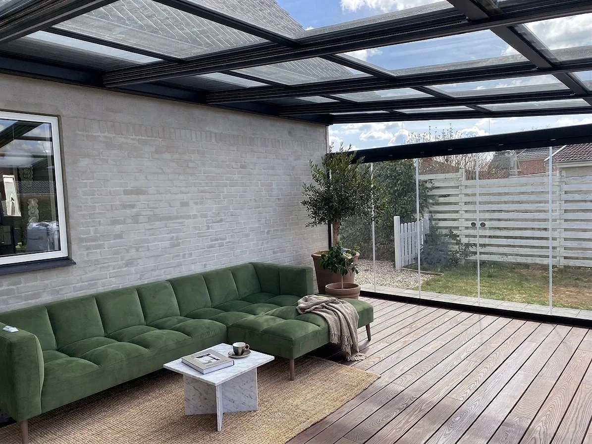 Terraza protegida con un techo móvil y paneles de cristal